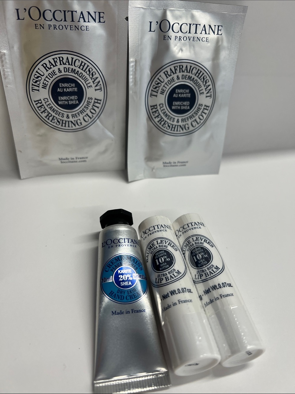 L’Occitane set of 5 travel Items Handcream, 2 lip balms and 2 Refresh Cloths New